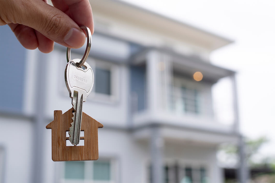 New homeowner holding keys to luxury family home