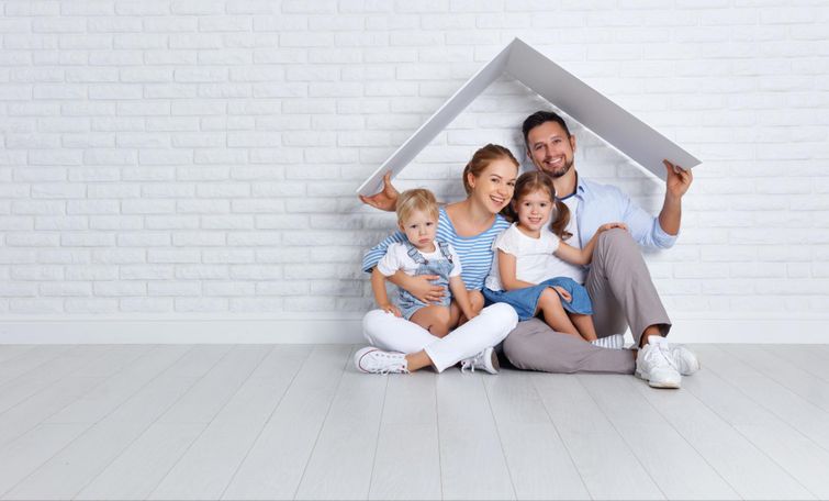 New family smiling while pretending to play house